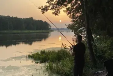 Sunset over calm waters, creating optimal fishing conditions